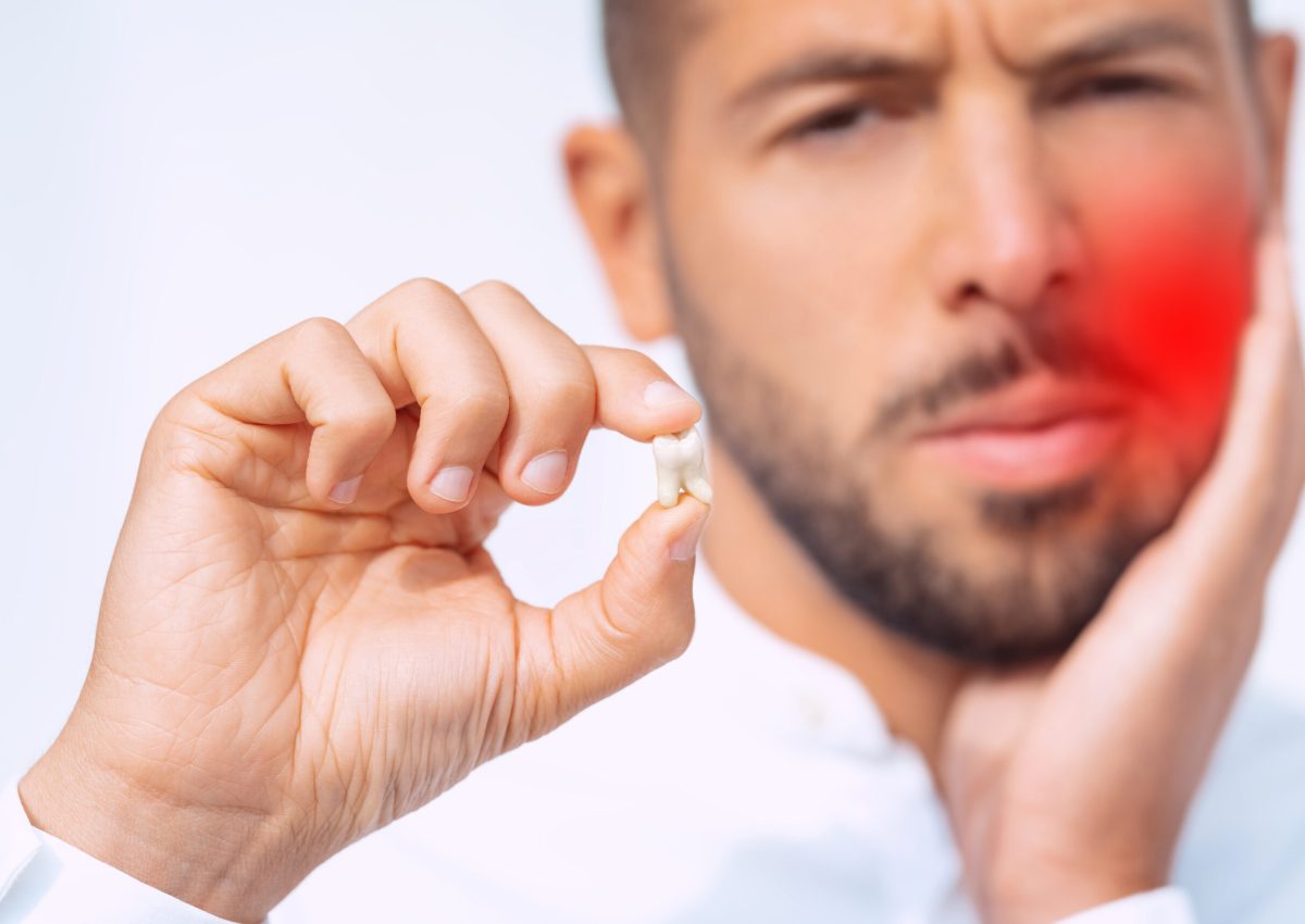Man feeling pain after tooth extraction or tooth removal surgery. High quality photo