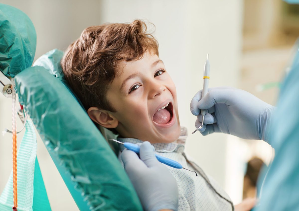 Beautiful child smiling while sitting in the dentist's chair. Close-up.